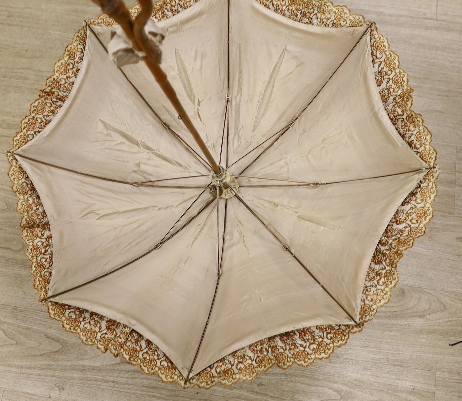 An embroidered parasol with bamboo handle. 88.5cm high